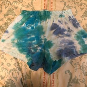 Blue tie-dye Soffe shorts, rollover band